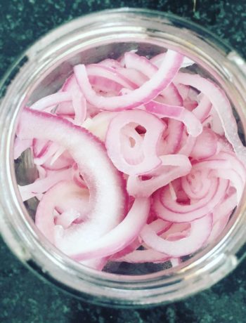 red pickled onions in a jar